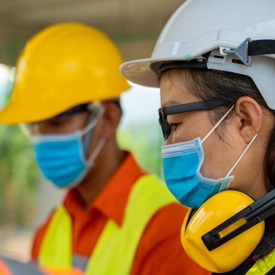 Engineer wearing protective mask to Protect Against Covid-19 wor Engineer wearing protective mask to Protect Against Covid-19 working at construction site,Architect Engineer Meeting People Brainstorming Concept.